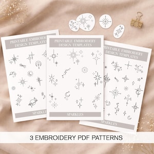 May include: Three printable embroidery design templates featuring celestial and starburst patterns in black and white. The templates include the text "Sparkles" and "Printable Embroidery Design Templates". The image also includes three small star-shaped cutouts.