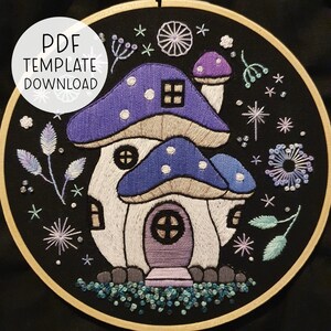 May include: Embroidered mushroom house with a purple door and white trim, surrounded by stars, flowers, and leaves on a black background.  PDF Template Download.