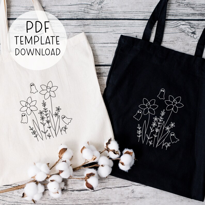 May include: Two tote bags with a ghost and flower design. The bag on the left is white with black embroidery. The bag on the right is black with white embroidery. Both bags have the text "PDF TEMPLATE DOWNLOAD" on them.