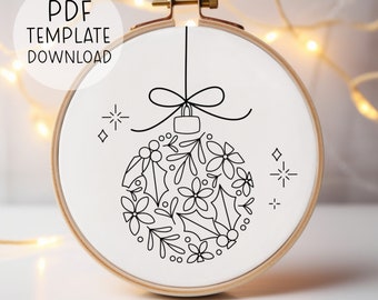 May include: A black and white line drawing of a Christmas ornament with a bow on top. The ornament is filled with floral designs and holly leaves. The image is on a white background.
