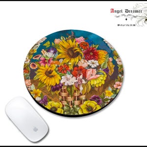 May include: Round mousepad featuring a vibrant floral arrangement in a woven basket. The design includes sunflowers, daisies, and other colorful flowers against a teal background. A white computer mouse is next to the mousepad.