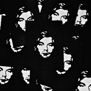 May include: Black and white graphic print of multiple faces on a black background. The faces are all similar in style and feature a simple, stylized design.