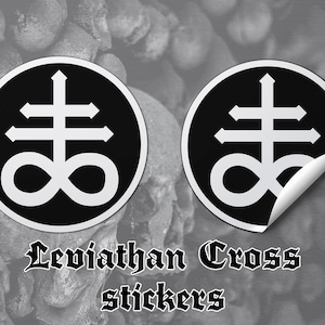 May include: Two black and white stickers with the Leviathan Cross symbol. The stickers are on a gray background with the text "Leviathan Cross stickers".