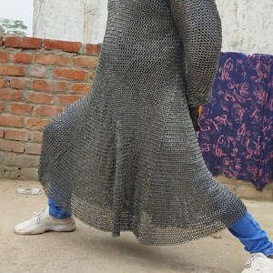 Close-up of chainmail mittens and coif detail in battle-ready armor