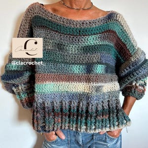 May include: A long-sleeved crochet jumper featuring horizontal stripes in shades of teal, forest green, brown, grey, and cream. The garment has a wide boat neckline and a ribbed hem. A rectangular logo with the text Clacrochet @clacrochet_ is visible.