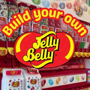 May include: A display of Jelly Belly jelly beans with the text "Build your own" in yellow and red. The Jelly Belly logo is prominently displayed. Various flavors are visible in clear containers, and bags of jelly beans are in the foreground. The words "The original gourmet jelly bean" are also visible.