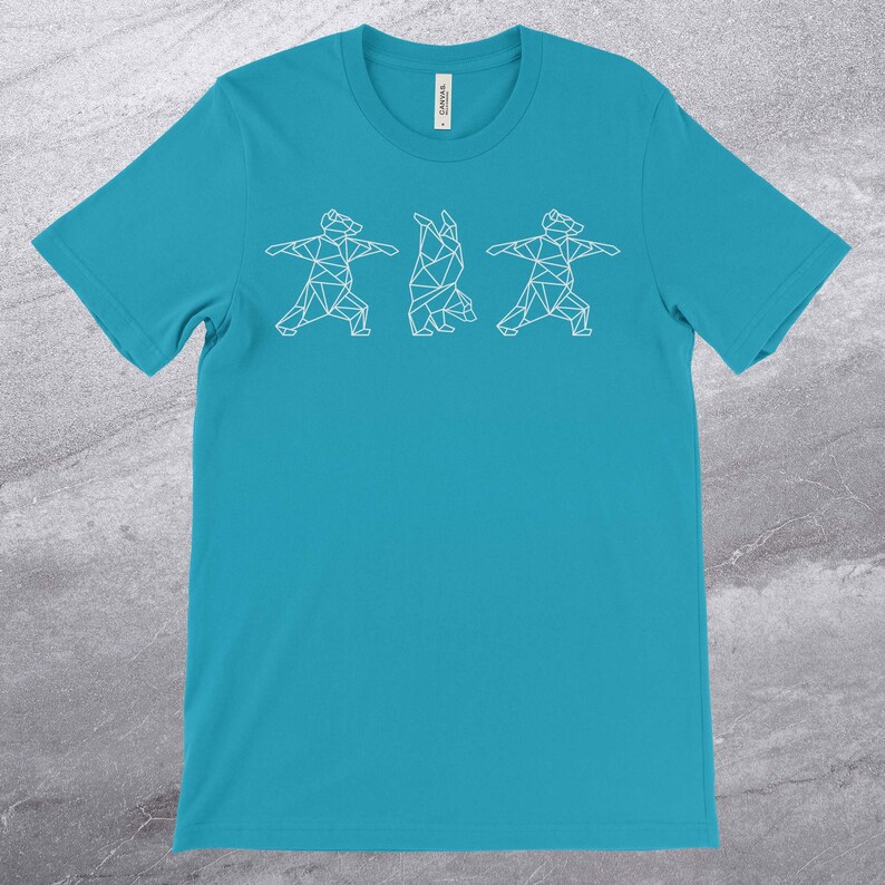 May include: A turquoise blue t-shirt with a white geometric design of three bears doing yoga poses.