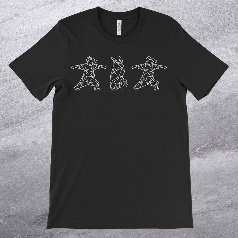 May include: Black t-shirt with a white geometric design of three bears doing yoga poses.