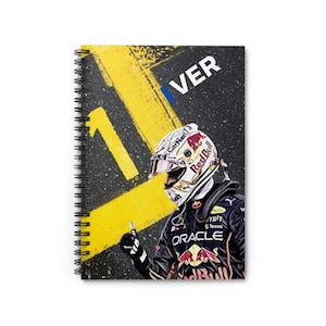 May include: A black and yellow notebook with a photo of a race car driver wearing a red and white helmet. The driver is giving a thumbs up. The number "1" is painted on the cover in yellow and the word "VER" is written in white. The driver's racing suit has the words "Red Bull" and "Oracle" on it.