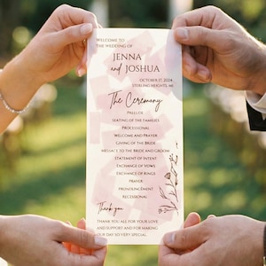 May include: A wedding ceremony program held by a couple. The program is a pale pink color with the names "Jenna and Joshua" at the top. The program includes the ceremony details and floral accents.