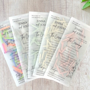 May include: Five clear plastic bags with white text and confetti inside. The text reads "Welcome to the wedding of Jenna and Joshua" and "The Ceremony".