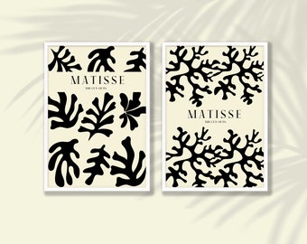Könnte beinhalten: Zwei gerahmte Drucke mit schwarzen und weißen Ausschnitten von Henri Matisse. Die Drucke enthalten den Text "Matisse The Cut-Outs".