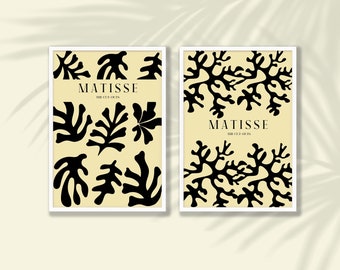 Könnte beinhalten: Zwei gerahmte Kunstdrucke mit schwarzen Matisse-Ausschnitt-Designs auf cremefarbenem Hintergrund. Der Text "MATISSE THE CUT-OUTS" befindet sich oben auf jedem Druck. Die Drucke sind in weißen Rahmen.