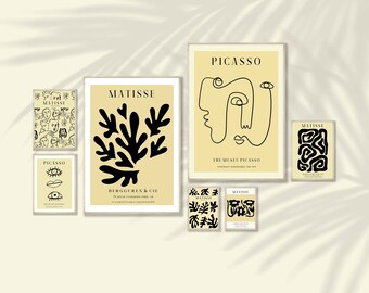 May include: A collection of framed art prints featuring the works of Matisse and Picasso. The prints showcase abstract designs, line drawings, and botanical shapes in black and cream colors. The prints vary in size and include text.