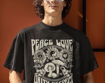 May include: Black t-shirt with a vintage-style graphic featuring the words "Peace Love Unity Respect" surrounded by flowers, mushrooms, and a yin-yang symbol.