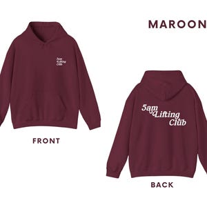 May include: Maroon hoodie with the text "5am Lifting Club" in white on the back and the same text in a smaller size on the front.