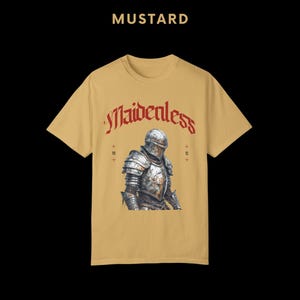 May include: A mustard yellow t-shirt with a graphic of a knight in armor. The text "Maidenless" is printed in red above the knight.