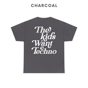 May include: A charcoal gray t-shirt with the text "The Kids Want Techno" printed in white.