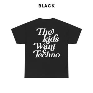 May include: Black t-shirt with white text that reads "The kids want Techno".