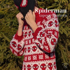 May include: A red and white knit jumper featuring a repeating Spiderman mask pattern and geometric motifs. The text Spiderman tapestry pattern is visible in the upper right corner. The jumper has long sleeves and a crew neckline.