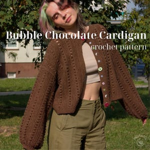 May include: A brown crochet cardigan featuring a bubble stitch texture, long sleeves, and a row of multicolored buttons. The text Bubble Chocolate Cardigan crochet pattern is overlaid on the image. The garment is worn over a beige top.