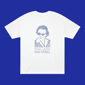May include: White t-shirt with a blue line drawing of Marie-Louise von Franz wearing sunglasses. The text "Marie-Louise von Franz" is printed below the image.