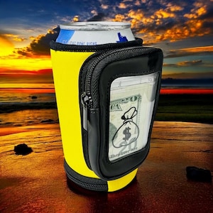 May include: Yellow neoprene can cooler with a black zippered pouch. The pouch has a clear window that shows a $20 bill with a money bag graphic and the text "They love Abe".