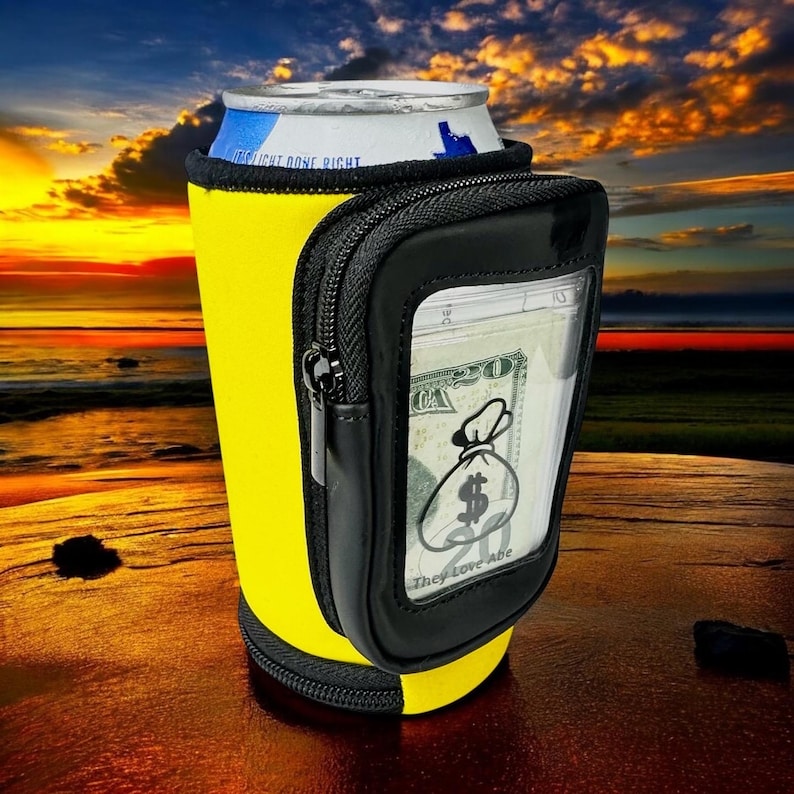 May include: Yellow neoprene can cooler with a black zippered pouch. The pouch has a clear window that shows a $20 bill with a money bag graphic and the text "They love Abe".