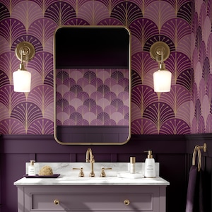 May include: A luxurious bathroom with a purple and gold art deco design. The vanity has a marble countertop, gold fixtures, and a rectangular mirror. The walls are adorned with a fan-shaped pattern wallpaper, and the room is illuminated by sconces.
