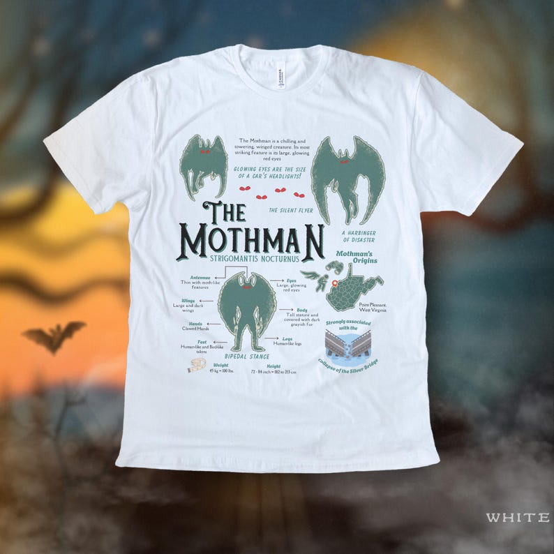 May include: White t-shirt with a green and black illustration of the Mothman, a cryptid from Point Pleasant, West Virginia. The illustration includes the creature's physical characteristics and the text "The Mothman, The Silent Flyer, Strigomantis Nocturnus, A Harbinger of Disaster, Mothman's Origins".