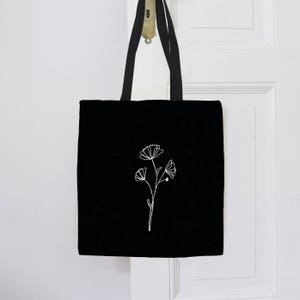 Schwarze Tragetasche mit Blume | 100% Baumwolle Jutebeutel | Line Art Tasche Ginkgo Motiv | Nachhaltige schwarze Umhängetasche Blume