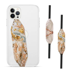 Switchbands reversible phone grip strap – Wood Resin Pearl design. Features a sophisticated 3D pattern combining natural wood textures with elegant resin and pearl accents. Provides a secure, comfortable grip while adding a refined, nature-inspired touch to your phone. The reversible design offers versatility, perfect for those who love chic, earthy aesthetics with a hint of luxury.