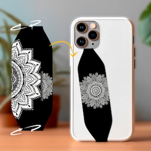 May include: A white and black phone case with a mandala design. The case has a black strap with a white floral pattern. The phone case is shown next to a detached strap with the same design.