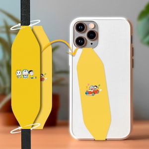 May include: A yellow phone case with a cartoon image of two characters in a red car. The case is attached to a yellow strap with a black strap.