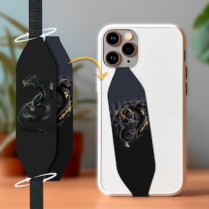 May include: Black phone case with a black dragon design and gold accents. The case is attached to a black phone strap with a dragon design.