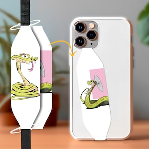 May include: White iPhone case with a cartoon snake design. The snake is yellow and green with a pink tongue and is coiled. The case has a matching strap with a black woven design.