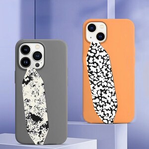May include: Two phone cases with a black and white abstract design on the back. The case on the left is gray and the case on the right is orange.