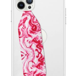 May include: A clear phone case featuring a red and white marble pattern on a grip. The case has a camera aperture and a white circular area for a MagSafe charger. The case is designed to fit a smartphone.