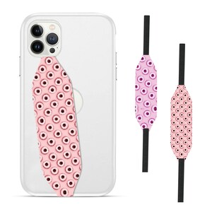 Switchbands reversible phone grip strap – Berry Donut design. Features a playful 3D pattern with a deliciously vibrant berry donut design, complete with colorful sprinkles. Provides a secure, comfortable grip for your phone while adding a sweet and fun touch to your device. The reversible design allows for easy style changes. Perfect for those who love whimsical, tasty-inspired designs and want to add a pop of personality to their phone.