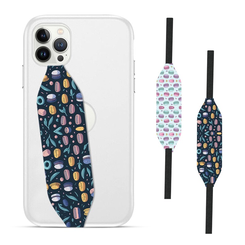 Switchbands reversible phone grip strap – Macaron design. Features a sweet 3D pattern inspired by pastel-colored macarons, with soft, delicate hues and charming details. Provides a secure, comfortable grip for your phone while adding a fun, elegant touch. The reversible design lets you switch up your style effortlessly. Perfect for those who love lighthearted, food-inspired designs and want a touch of whimsy on their phone.