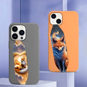 May include: Two phone cases featuring a fox design. The case on the left is grey with a fox in a heart-shaped cloud. The case on the right is orange with a blue and orange fox.