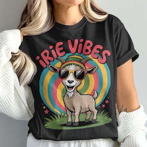 May include: Black t-shirt featuring a cartoon goat wearing sunglasses and a hat, with the text "iRIE VIBES" in pink. The goat is set against a colorful, circular background with stars and grass.
