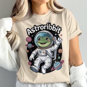 Astroribbit T-Shirt, Frog Astronaut, Space T Shirt, Cute Graphic Tee, Planet Design, Galaxy Shirt, Funny Tee, Unisex Clothing, Cool T-Shirt