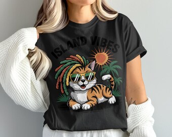 May include: Black t-shirt featuring a cartoon cat with sunglasses and dreadlocks. The cat is orange and white with tiger stripes, and the shirt has the words "ISLAND VIBES" above the cat, with a sun and palm trees in the background.