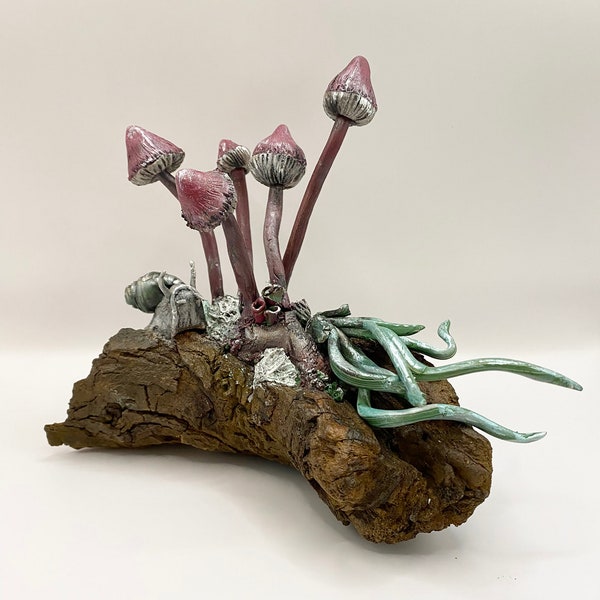 Mushroom sculpture with snail and sculpted air plant