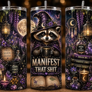 May include: A cylindrical tumbler featuring a raccoon wearing a witch hat, holding a mug, and the text "MANIFEST THAT SHIT" above an open book. The design includes purple flowers, a full moon, lanterns, crystals, and books labeled "DREAM BIG."