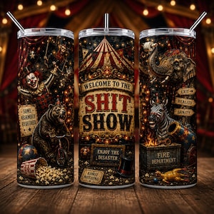 May include: A cylindrical tumbler with a metal straw featuring a dark circus theme. The design includes a clown, a bear on a bicycle, an elephant, a zebra, and text reading "WELCOME TO THE SHIT SHOW," "SOME ASSEMBLY REQUIRED," "ENJOY THE DISASTER," and "ADMIT NOTHING."