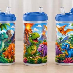 May include: Three clear plastic tumblers with blue lids and flip-up straws, each featuring a colorful wrap-around illustration of various dinosaurs in a prehistoric landscape with volcanoes, palm trees, and lush tropical foliage.