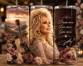 May include: A cylindrical tumbler with a metal straw featuring a portrait of Dolly Parton, a mountain landscape at sunset, an acoustic guitar, and roses. The text reads: Dream more. Love more. Give more. Dolly, with decorative heart accents.