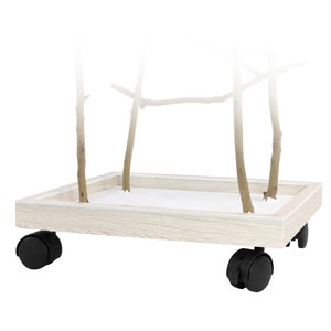 May include: A wooden bird perch stand with natural branches. The stand has a light wood grain finish and sits on a rectangular base with four black caster wheels for easy movement. The base has a white interior.